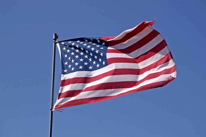 Waving American flag against a clear blue sky