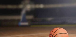 A basketball resting on a wooden court