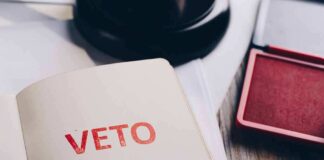 A stamped document with the word 'VETO' in red ink