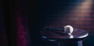 Microphone resting on a stool on stage.