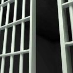 DERANGED Jailbreak Plot — Caught Red-Handed Close-up of prison cell bars.