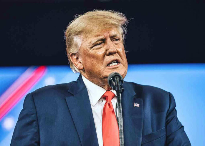 Man in suit speaking at a podium.