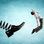 Diplomat Kicked Out—Spy Accusations Fly! Man gets kicked by oversized shoe on spring.