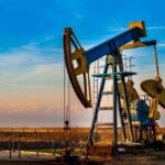DESPICABLE Reason California IMPORTS Oil Despite MASSIVE Reserves An oil pump jack operating against a sunset backdrop