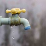 Close-up of a dripping outdoor water faucet