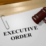 A gavel resting on a document labeled 'EXECUTIVE ORDER'