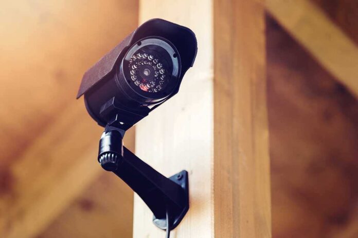 A security camera mounted on a wooden wall