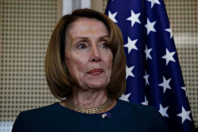 Person standing in front of an American flag.