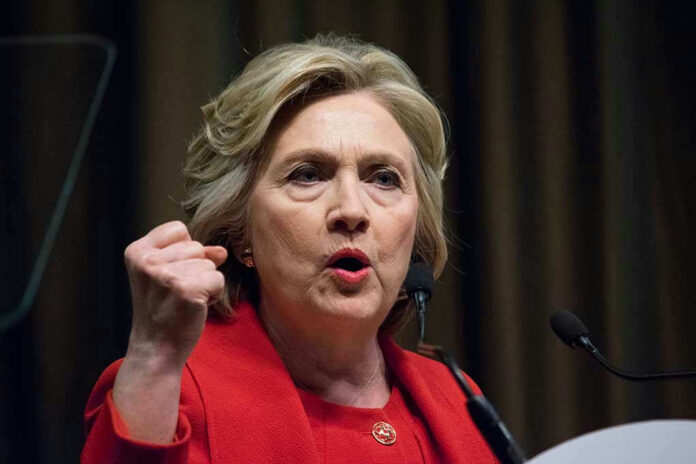 Person speaking passionately at a podium, wearing red jacket.