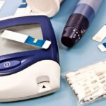 Air Force Insider STEALS $3M—Diabetics Left Stranded Blood glucose monitor with testing strips and a lancing device on a blue background
