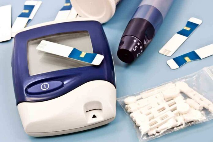 Blood glucose monitor with testing strips and a lancing device on a blue background