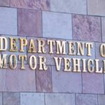 Sign for the Department of Motor Vehicles on a stone wall