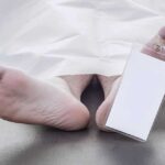Autopsy Delay Fuels Mystery in High-Profile Case Feet of a deceased person covered by a white sheet with an identification tag