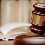 Wife Beating LEGALIZED — Horrifying New Code A wooden gavel resting on a sound block with law books in the background