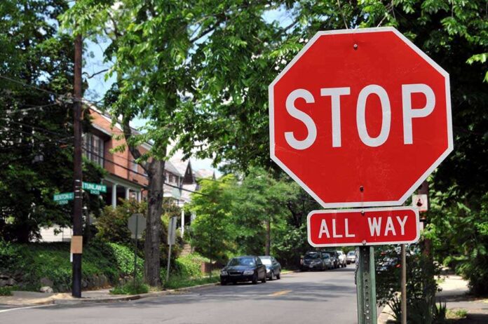 shutterstock_31296277.jpg A red stop sign with the words STOP and ALL WAY in a residential area