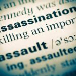 Intelligence Boss SHOT Multiple Times—Suspect Gone Close-up of a dictionary page showing the definition of 'assassination'