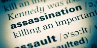 Close-up of a dictionary page showing the definition of assassination