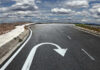 Curved road with a U-turn arrow marking.