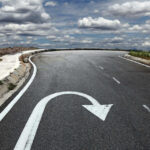 Curved road with a U-turn arrow marking.