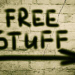 Graffiti on brick wall says free stuff arrow