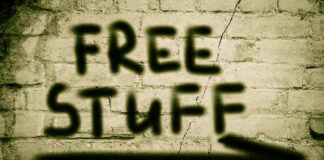 Graffiti on brick wall says free stuff arrow