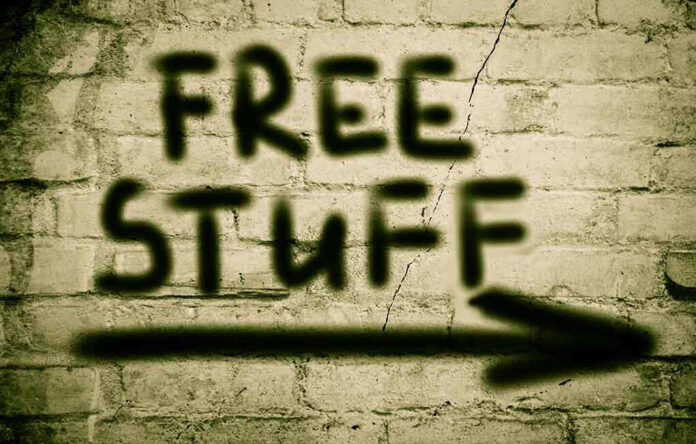 Graffiti on brick wall says free stuff arrow