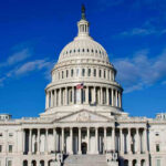 US Capitol Building against blue sky.