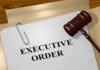 A gavel resting on a document labeled 'EXECUTIVE ORDER'