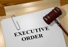 A gavel resting on a document labeled 'EXECUTIVE ORDER'