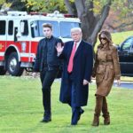 Barron Trump Hit by Media Mockery A family walking together outdoors in autumn