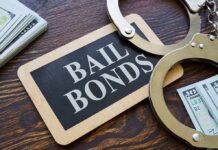 A bail bonds sign with handcuffs and stacks of cash