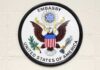 Seal of the United States Embassy featuring an eagle and the American flag