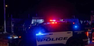 Houston police vehicle with emergency lights activated at night