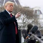 Donald Trump gesturing while speaking to the press outside