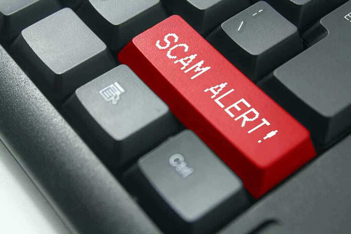 Close-up of keyboard with red SCAM ALERT key.