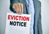 Man holding eviction notice in hand