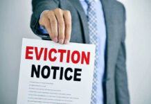Man holding eviction notice in hand