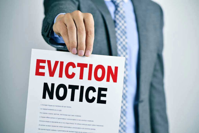 Man holding eviction notice in hand