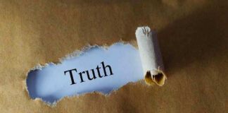 Ripped paper reveals word truth underneath brown surface