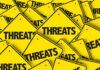 Treasury’s URGENT WARNING–Financial Systems SUDDENLY VULNERABLE Yellow warning signs with the word THREATS.