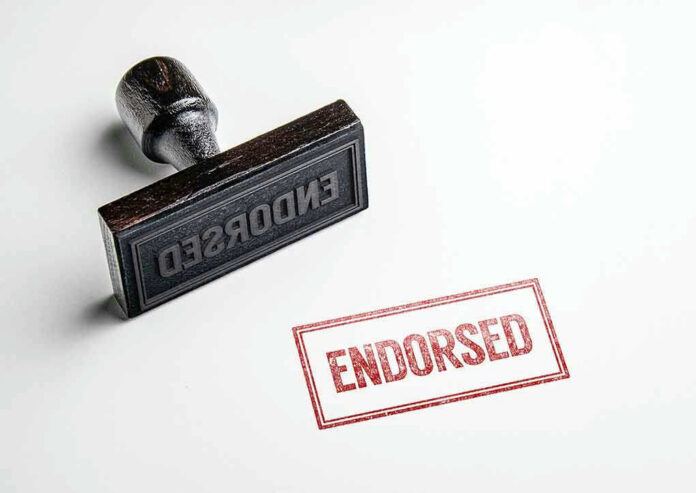 621176360 Rubber stamp with ENDORSED text on paper.