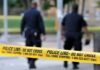 Rising Politician Found Dead — SHOCKING Arrest Police officers walking past caution tape at a crime scene