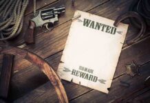 Bounty on U.S. Pilot—Iran’s Dangerous Game A vintage wanted poster alongside a revolver and rope on a wooden table
