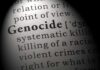 Close-up of the word 'Genocide' in a dictionary with its definition