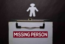 Clipboard with a missing person notice and a paper cutout figure