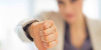 Businesswoman showing a thumbs down gesture in an office setting