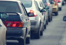 A line of cars stuck in traffic on a roadway