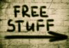 Graffiti on a brick wall stating FREE STUFF with an arrow