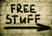 Graffiti on a brick wall stating FREE STUFF with an arrow