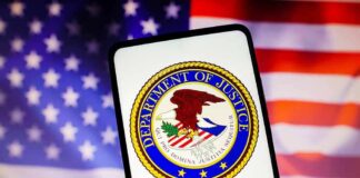 Department of Justice emblem displayed on a smartphone with an American flag background
